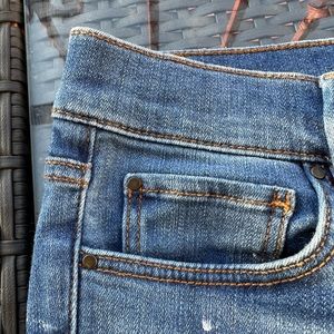 Ann Taylor denim pants with black lace detailing on the cuffs